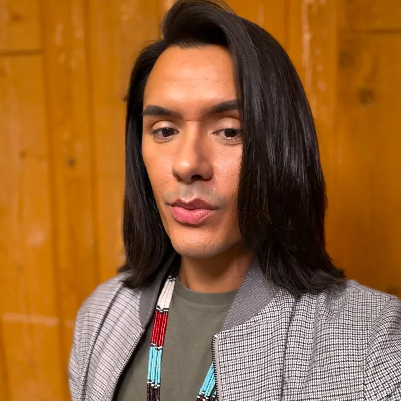 Casey today, wearing a houndstooth jacket and a beaded necklace